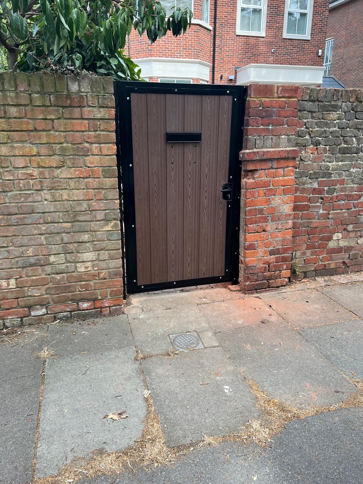 Single pedestrian steel gate with composite infill and letterbox.